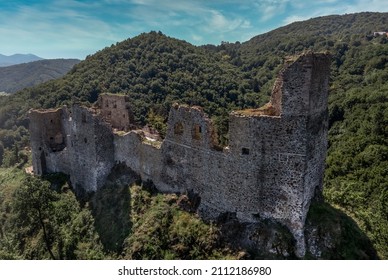 Aerial view of medieval castle ruin Reviste above the Hron river in central Slovakia with square tower, double gate, round gate tower on a hilltop