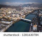 Aerial view of medieval city Olten with old wooden bridge, railway station, Jura mountains, Aare,  Kantonsschule Olten during Winter with snow on rooftops