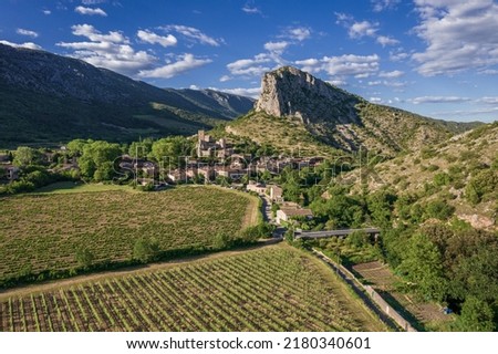 Aerial view of a medieval village, Saint-Jean-de-Bueges with vineyard on mountains in summer in France