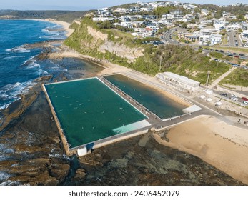 Aerial view of Merewether Ocean Baths - a large public swimming pool adjacent to the beach in Merewether.