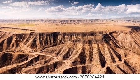 Aerial view of mesa or flat topped ridge in mountains with steep slopes in a high-altitude plateau. Geology formations and travel destinations