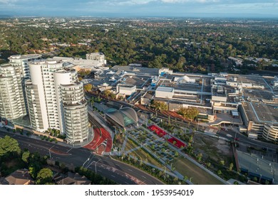 Aerial view of metro station, shopping centre, and nearby high-rise apartments, Castle Hill, Australia.