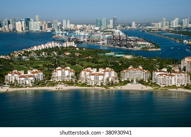 aerial view of miami port entrance and city skyline, with fisher island in foreground, on clear morning, 2016