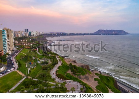 Aerial view of Miraflores Malecon park by the ocean in Lima, Peru. People, tourists and cyclists having fun in 