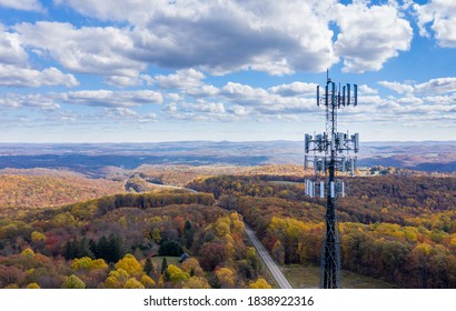 Aerial view of mobiel phone cell tower over forested rural area of West Virginia to illustrate lack of broadband internet service