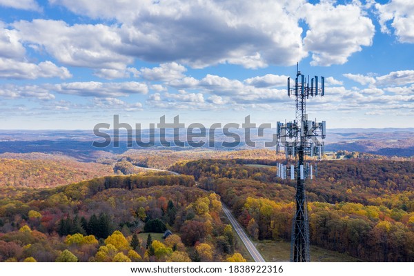 Mobile phone tower and aerials with rural wooden landscape stock photo