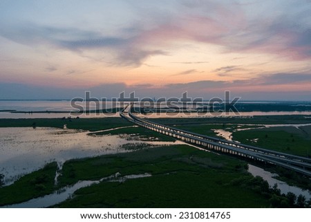 Aerial view of Mobile Bay and interstate 10 bridge at sunset in May 2023