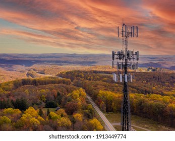 Aerial view of mobile phone cell tower over forested rural area of West Virginia to illustrate lack of broadband internet service - Shutterstock ID 1913449774