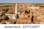 Aerial view of the Modena Cathedral and Torre della Ghirlandina, the bell tower of this Roman Catholic church. In background there is the Ducal Palace of Modena, Emilia Romagna, Italy.