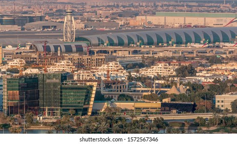 Aerial View Of Modern City With Attractive Buildings And Big Airport At Sunset Aerial Timelapse, Dubai Creek, Dubai, United Arab Emirates