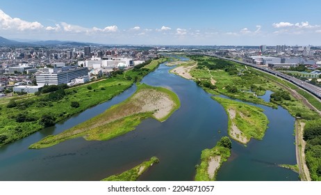 Aerial View Of Modern City And River. Drone Point Of View.