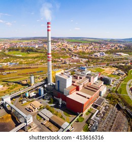 Aerial view of modern combined heat and power plant. Fuming chimney with sulphur removal unit. Heavy industry from above. Power and fuel generation in Czech Republic, European Union. 