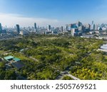 Aerial view modern office building with tropical green tree park in Benchakitti public park downtown of Bangkok Thailand