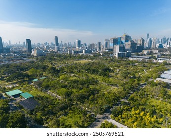 Aerial view modern office building with tropical green tree park in Benchakitti public park downtown of Bangkok Thailand - Powered by Shutterstock