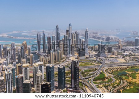 Aerial view of modern skyscrapers and sea in the background, Dubai, United Arab Emirates.