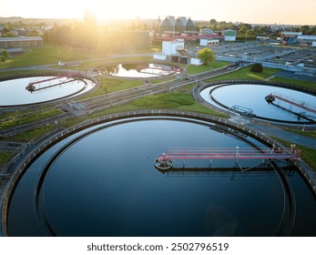 Aerial view of modern wastewater treatment plant with storage tanks in sunset. Ideal for wastewater management theme.