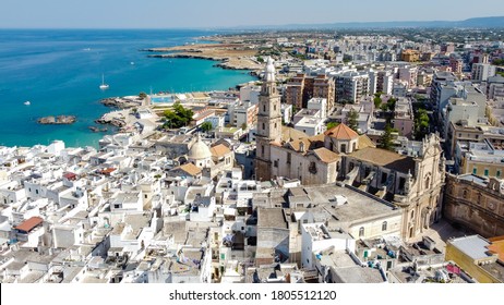 Aerial view of Monopoli in Apulia, south of Italy - Monopoli Cathedral aka Basilica of the Madonna della Madia from above, in front of the Adriatic Sea