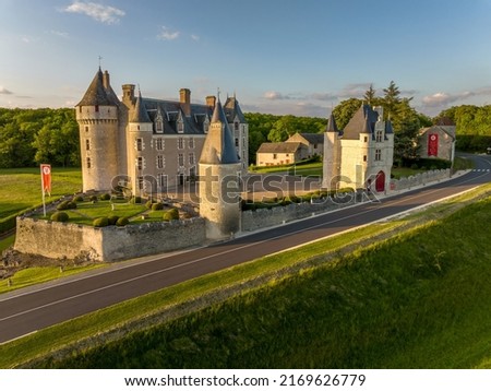 Aerial view of Montpoupon castle, French Renaissance chateau in the Loire Valley with round towers , gate house in a forested valley