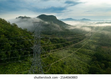 Aerial view Morning scenic on high mountains forest with electricity pylon Pang Puay, Mae Moh, Lampang, Thailand. Beautiful morning with golden sunrise and fog flowing. - Shutterstock ID 2164060883