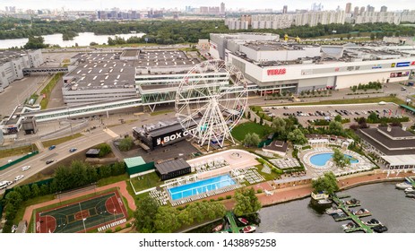 Aerial View. Moscow, Russia 06/2019: Merry Go Round In Vegas Trade Center Outside In Street. Ferris Wheel Myakinino, Krasnogorsk City. Pavshinskaya Poima. Musement Park, Urban Landscape Carousel. Pool