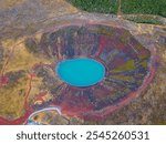 Aerial view of the most colorful volcano crater in Iceland - Kerid Crater, filled with turquoise water