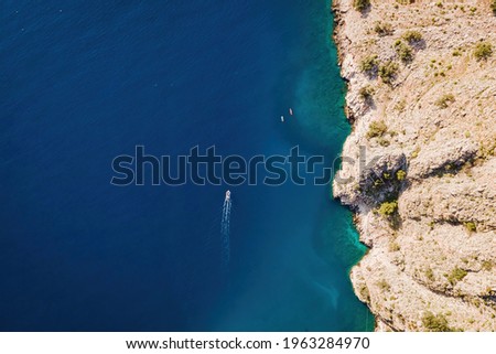 Aerial view of motor boat with White Trace Of Speed Boat Sailing Toward in sea. Holiday Tourism Concept