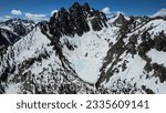 Aerial view of the Mount Heyburn and the frozen Upper bench lake. Shot in Sawtooth mountain range, Stanley, Idaho state, USA. 