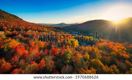 Aerial view of Mountain Forests with Brilliant Fall Colors in Autumn at Sunrise, Adirondacks, New York, New England