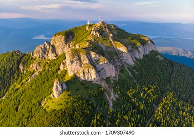 Aerial view of mountain peak: stairs for tourists in a summer landscape, Ceahlau mountain in Romanian Carpathians