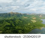 Aerial view of Mountains covered rainforest and trees. Blue sky with clouds. Coron, Palawan. Philippines.