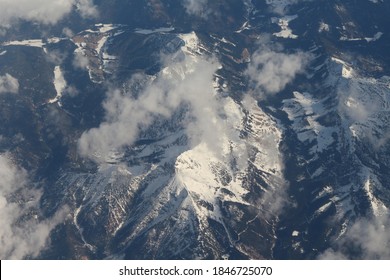 Aerial View Of The Mountains.  Snow Mountain Tips, Crystal Blue Sky.