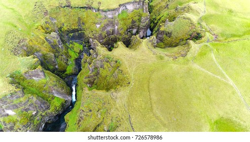 Aerial view of mountains and waterfalls in Fjadrargljufur canyon, Iceland.