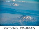 Aerial view of Mt St Helens and Mt Rainier from the airplane.