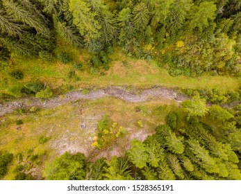 Aerial View Of Mud Slide River Bed In Mountain Forest In Switzerland.