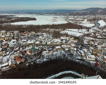 Aerial View Of Mukachevo Zakarpattia, Ukraine. Roofs Covered With Snow, Winter View Of The City. Solar Panels On The Roof, Energy Independence, Green Tariff, Alternative Energy Sources