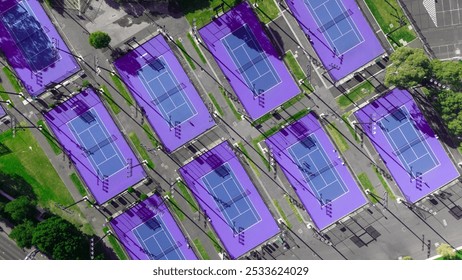 Aerial view of multiple purple tennis courts in a park setting with surrounding greenery. - Powered by Shutterstock