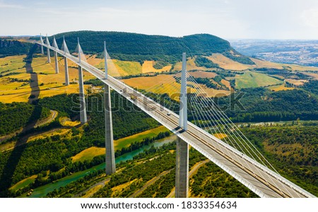 Aerial view of multispan cable stayed Millau Viaduct across gorge valley of Tarn River in Southern France in summer