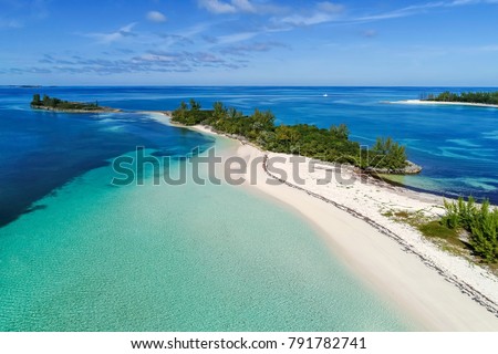Aerial view of Munjack Cay with bay and beach in Abaco, Bahamas. Green turtles and stingrays inhabit the area.