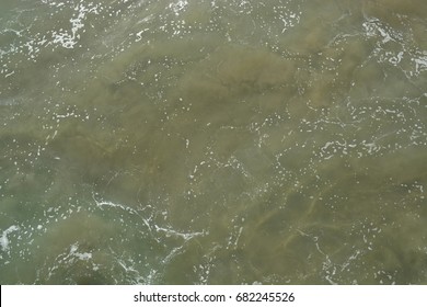 Aerial view of murky greenish brown ocean water - Shutterstock ID 682245526