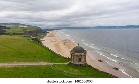 Aerial view of Mussenden Temple which  is a building located on cliffs and above the Atlantic Ocean. Castlerock, Co Derry, Northern Ireland.