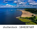 Aerial view of the Nallikari beach, partly sunny, summer morning, at the Bothnian Bay, in Oulu, North Ostrobothnia, Finland - drone shot