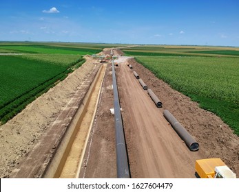 Aerial View of Natural Gas Pipeline Construction in Cultivated Agricultural Farm Field - Turkish Stream. Aerial Drone View of a Construction Site of the European Natural Gas Pipeline. 