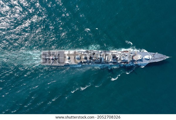 Aerial view of\
naval ship, battle ship, warship, Military ship resilient and armed\
with weapon systems, though armament on troop transports. support\
navy ship. Military sea\
transport.