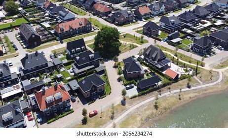 Aerial view of nearly finished construction project of new real estate property showing houses next to each other with some infrastructure still needs finishing solving Dutch housing shortage 4k