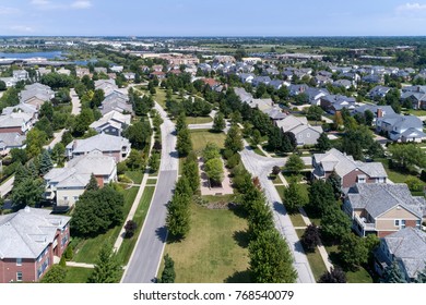 Aerial view of a neighborhood in suburban Chicago with homes on either side of a parkway.