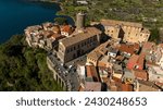 Aerial view of Nemi, a town of Castelli Romani regional park, in the Metropolitan City of Rome, Italy. The historic center is located in the Alban Hills overlooking Lake Nemi, a volcanic crater lake. 