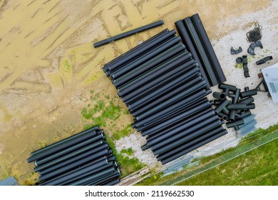 Aerial View New Black Plastic Pipes For The Drainage Pipes System On New Home Construction