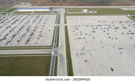 Aerial View Of New Cars Lined Up Parking Outside Factory On Car Factory Background.