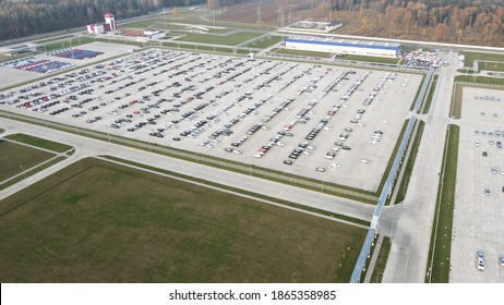 Aerial View Of New Cars Lined Up Parking Outside Factory On Car Factory Background.