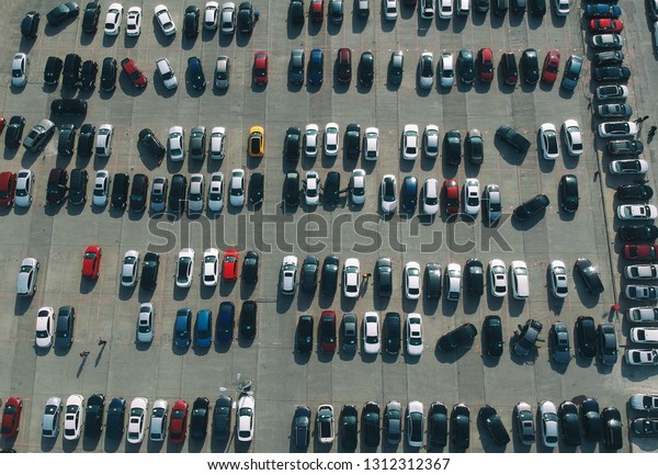 Aerial view of new cars in the\
parking.  imported new vehicles - outdoor parking various type\
cars
